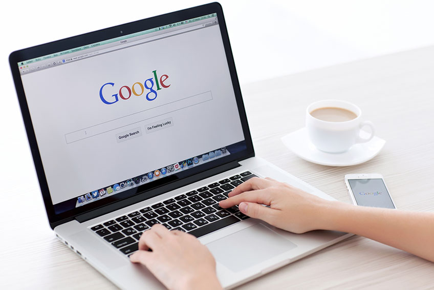 A Person Using a Laptop and Browsing on Google A Person Using a Laptop and Browsing on Google