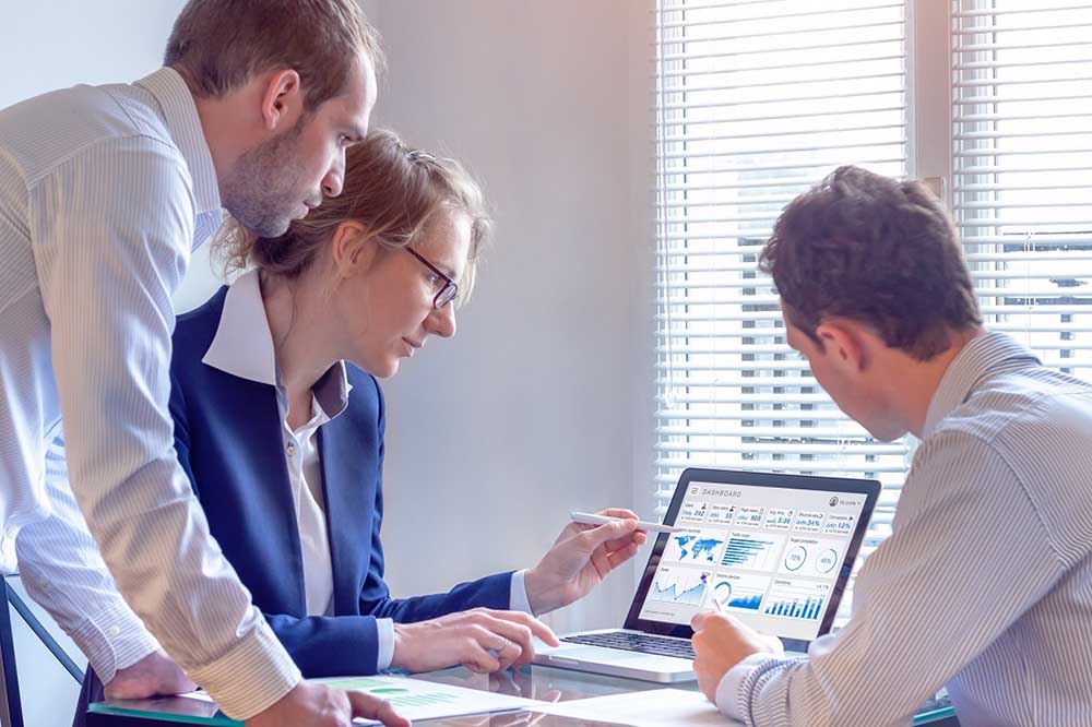 professional team collaborating around a screen with organized analytics and strategy charts professional team collaborating around a screen with organized analytics and strategy charts