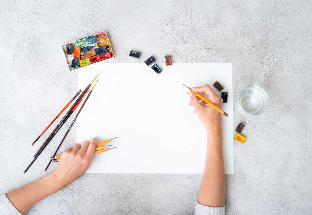 artist sketching on a blank page artist sketching on a blank page